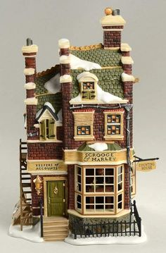 a toy model of a building with snow on the roof