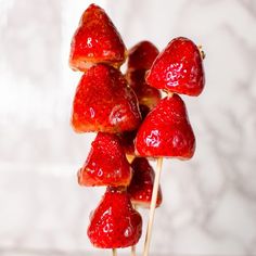 strawberries are arranged on top of each other with toothpicks in the shape of hearts