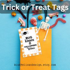 trick or treat bags for halloween with candy and candies on blue background, text overlay says trick or treat tags