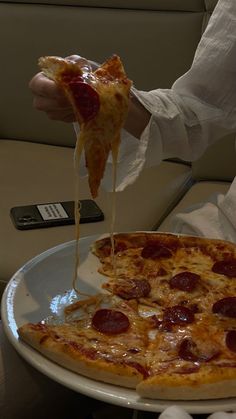 a person eating a slice of pizza on a plate