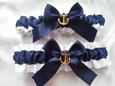 two navy blue and white garters with an anchor