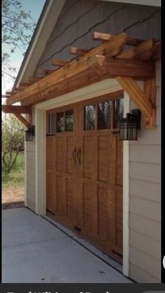 an outside view of a garage with wooden doors