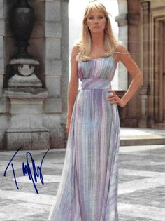 an autographed photo of a woman in a long dress with her hands on her hips