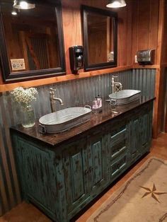 a bathroom with two sinks and mirrors on the wall next to a rug in front of it