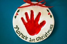 a ceramic ornament with a handprint on it that says world's 1st christmas