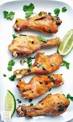 chicken wings with cilantro and lime on a white plate