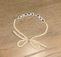 a beaded bracelet with the word ciara bow on it and beads attached to it