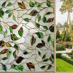 a stained glass window with green leaves on it