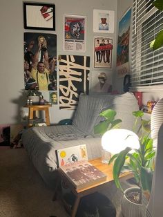 a living room filled with furniture and pictures on the wall