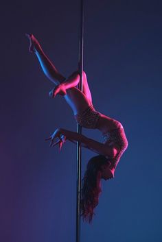 a pole dancer in the middle of an aerial acrobatic routine on a pole