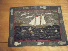 a rug with a sailboat on the water