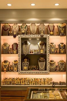 a display case filled with lots of gold jewelry