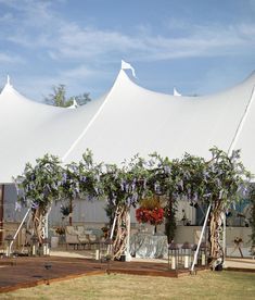 a large white tent with purple flowers on it