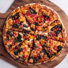 a pizza sitting on top of a wooden cutting board next to a knife and fork