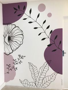 the wall is painted with black and white flowers on purple, pink and gray colors