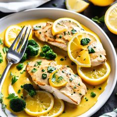 a white plate topped with chicken covered in lemons and garnished with parsley