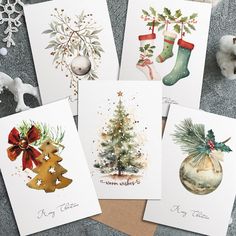 four christmas cards with watercolor designs on them