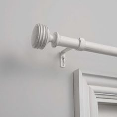 a white door handle on the side of a wall