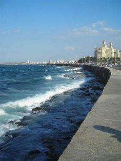 the water is very choppy and blue in this cityscape scene, with buildings on either side