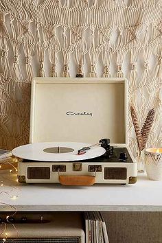 a white record player sitting on top of a table