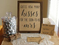 there is a sign that says guess how many kisses for the son - to - be mrs