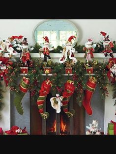 christmas stockings and decorations are hung over the fireplace