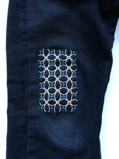 a piece of cloth has been stitched together to make a decorative pattern on it