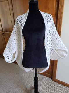 This midweight lacy crocheted shrug is great for all seasons, day and night.  Wear it in the summer over a strapless sundress or with a tank top and a pair of capri pants.  Fall and winter wear it over a turtle neck sweater with a pair of jeans.  Endless combinations.  This lacy shrub will easily take you through the day and on into the evening. This white shrug is ready to ship.  Great as a gift for mom, sis or a great friend. This shrug is hand crocheted using an acrylic yarn. I have sold several in beautiful pastel colors. One size fits most women.  If you would prefer a different color, please convo me.  As this is a custom order, please allow approximately 2 weeks for processing. Machine wash gentle cycle, tumble dry on low. White Shrug, Strapless Sundress, Summer Wraps, Crochet Shrug, Winter Wear, Crochet Shawl, Turtleneck Sweater, Shawls And Wraps, Hand Crochet