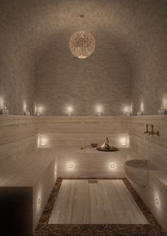 an indoor spa with lights on the walls and flooring, along with a circular chandelier