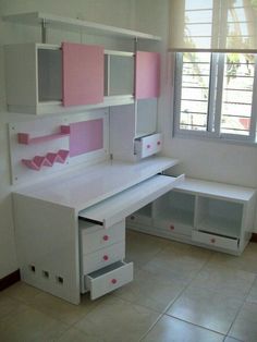 a white desk with pink and grey drawers in a room that has tile flooring