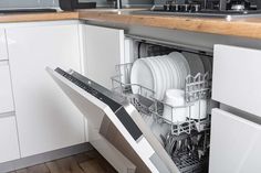 an open dishwasher with dishes in it