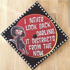 a graduation cap with the words i never look back daring it distracts from the now