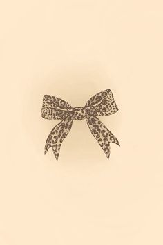 an animal print bow on a beige background