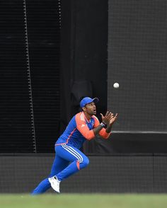 a baseball player catching a ball with his glove