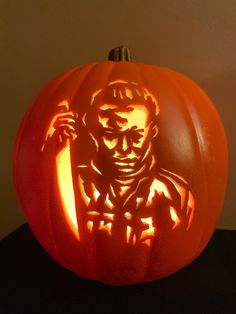 a carved pumpkin with the image of abraham lincoln on it's face and hands