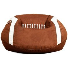 a brown dog bed with white piping on it