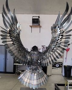 a large metal bird sitting on top of a table