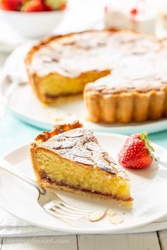 a piece of pie on a plate with a fork and strawberries in the background