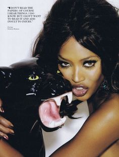 a woman holding a black cat with her mouth open