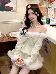 a woman sitting on top of a chair holding a piece of cake