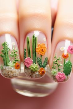 Embrace the vibrant spirit of Mexico with these Mexican themed nails showcasing a desert bloom. Featuring a terrarium effect with cacti and florals, these designs are a testament to Mexican nail art creativity. Discover more at nailhow.com for your nail art inspiration! Mexico Holiday Nails, Themed Nails Designs, Succulent Nail Art Designs, Desert Theme Nails, Oaxaca Inspired Nails, Encanto Nails, Mexican Nail Art Mexico, Cacti Nails, Succulent Nail Art