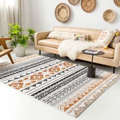 a living room filled with furniture and lots of pillows on top of a white floor