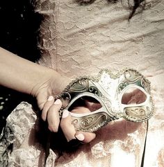 a close up of a person holding a mask