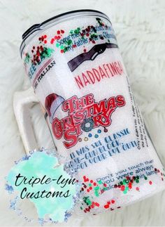 the christmas story coffee mug has been decorated with glitter and is next to a tag that says, naddatating