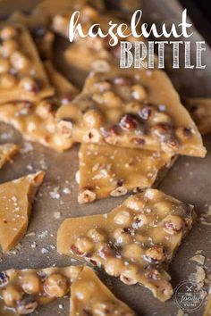 some kind of cracker brittle that is on a baking sheet with the words hazelnut brittle