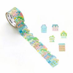 a roll of washi tape with houses and buildings on the side next to it