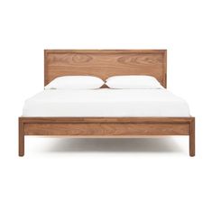 a wooden bed frame with white sheets and pillows on it, against a white background