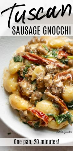 a white plate topped with pasta covered in sausage and spinach next to a fork