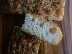 two pieces of bread sitting on top of a wooden cutting board