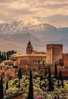 an old city with mountains in the background